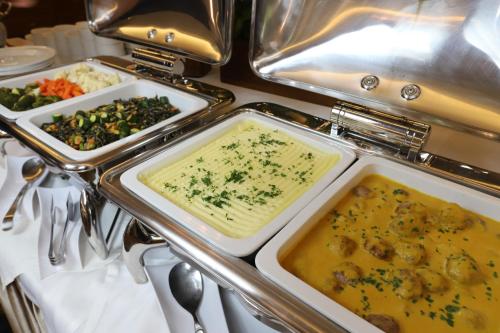 a buffet with two trays of food on a table at Hotel Lubicz in Ustka