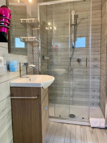 a bathroom with a sink and a shower at Villa Oasi in Ferrara