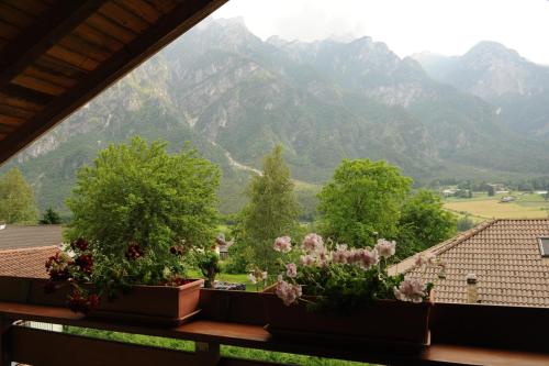 a view of mountains from a balcony with flowers at La Casa Del Gelsomino in Ospedaletto