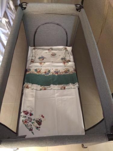 a baby crib in a box with christmas decorations at Fotini's Apartment in Nea Peramos