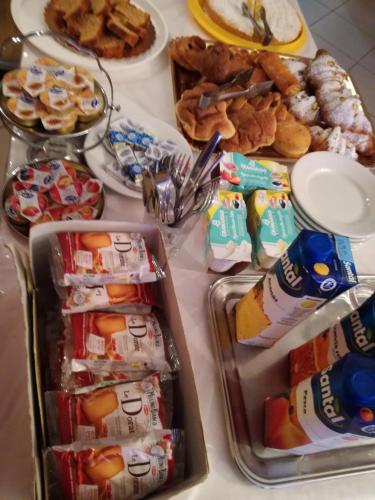a table topped with trays of food and snacks at Scacco Rosso in SantʼEgidio alla Vibrata
