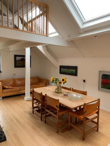 a living room with a table and a couch at Erve Feenstra in Lochem
