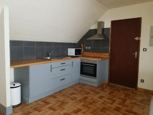 une cuisine avec un évier et un plan de travail dans l'établissement Joli petit appartement au calme, à Vignec