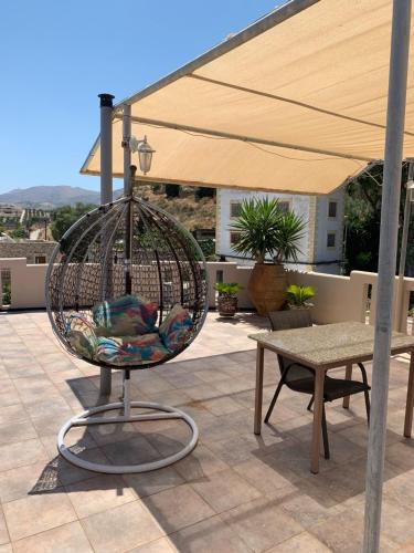 a bird cage sitting on top of a patio at Pension Nikos in Pitsidia