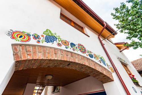 a building with colorful tiles on the side of it at Penzion Hluk in Hluk