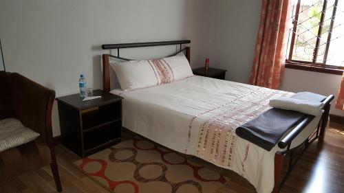 Ένα ή περισσότερα κρεβάτια σε δωμάτιο στο Kilimanjaro Country House