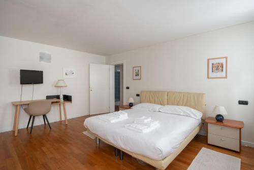 a bedroom with a bed and a desk and a television at Ca' Coriandolo in Venice