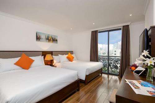 Postel nebo postele na pokoji v ubytování Roliva Hotel & Apartment Danang