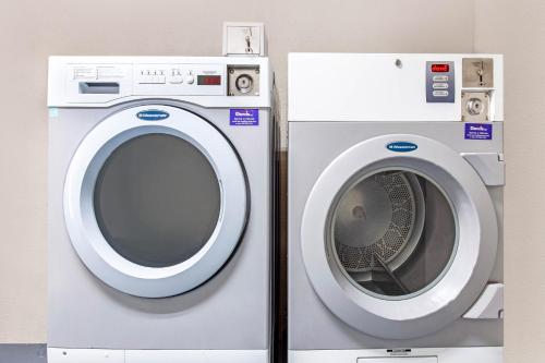 a washing machine and a dryer are next to each other at Baymont by Wyndham McDonough in McDonough