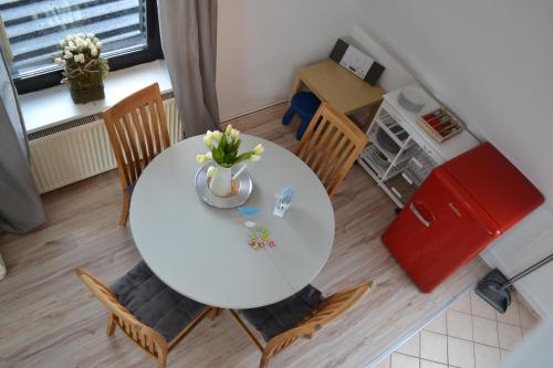 a table with a vase of flowers on it in a kitchen at Strandhof Holnis in Glücksburg