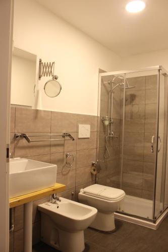a bathroom with a sink and a toilet and a shower at Umberto House Catania in Catania