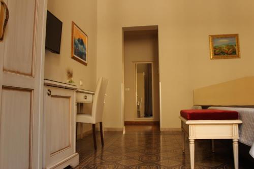 a room with a bed and a desk and a table at Umberto House Catania in Catania