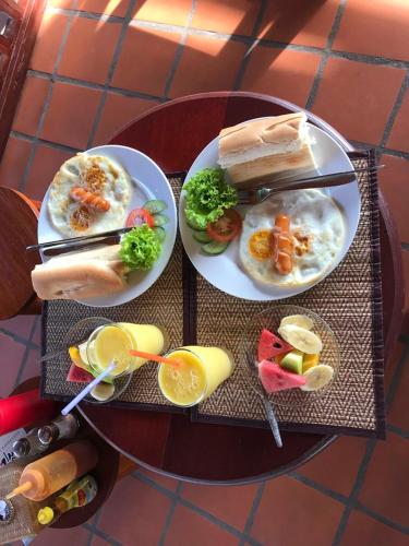 a table with two plates of food on top at Villa Rattanakon in Luang Prabang