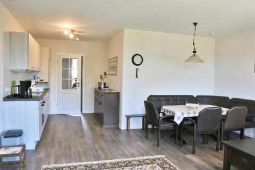 a kitchen and a dining room with a table and chairs at Landhaus - Hof Pakirnis in Bleckede