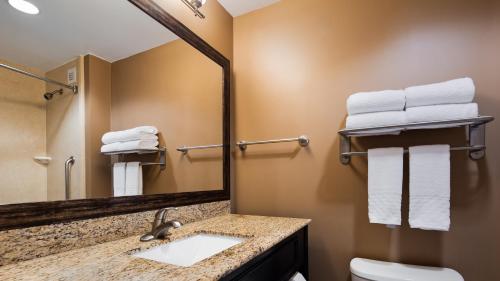a bathroom with a sink and a mirror at Best Western Plus College Park Hotel in College Park