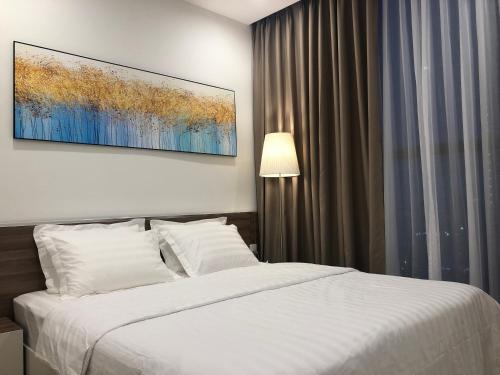 a bedroom with a bed and a painting on the wall at Luxury Condotel 2BR Vinhomes Skylake Keangnam - Netflix free in Hanoi
