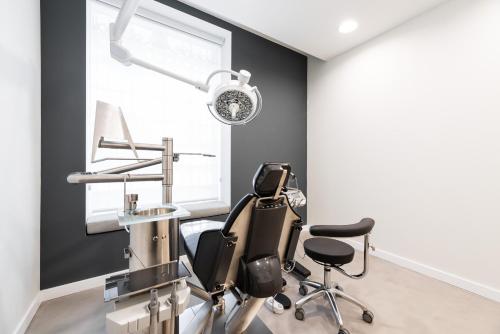 a dental office with a chair and a mirror at Eurostars Isla de La Toja in Isla de la Toja