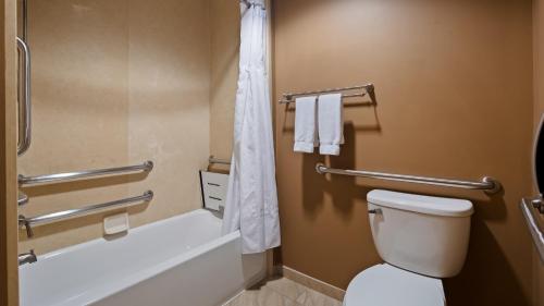 a bathroom with a toilet and a tub and a shower at Best Western Plus College Park Hotel in College Park