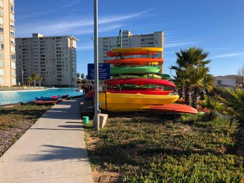 a group of boats lined up next to a pool at Vista Laguna Apartment in Algarrobo