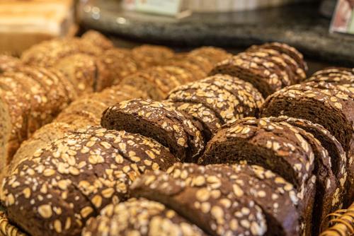 a pile of brown breads on a display at Hotel IPV Palace & Spa - Adults Recommended in Fuengirola