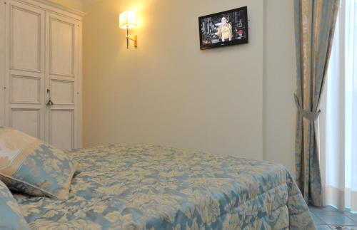 a bedroom with a bed and a picture on the wall at Hotel Santa Lucia in Minori
