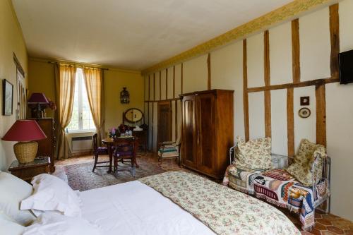 1 dormitorio con 1 cama y 1 silla en Ferme de la Haye, en Montroty