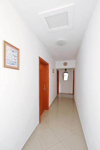 a hallway of a house with white walls and a door at Senkini Dvori in Sutomišćica