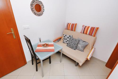 a table and a chair in a small room with a table and a table at Senkini Dvori in Sutomišćica