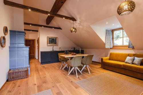 a living room with a couch and a table at Appartementhaus Plainstöckl Hotel Gasthof Maria Plain in Salzburg