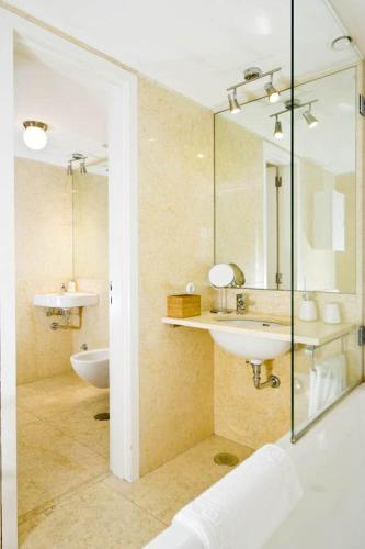 a bathroom with two sinks and a mirror at Chiado Design Apartment 5E in Lisbon