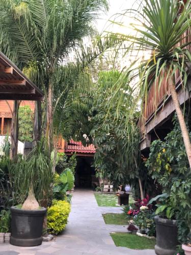 a garden in a resort with palm trees and plants at Cabañas La Finca in Atlixco