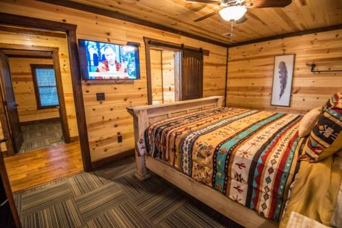 a bedroom with a bed in a log cabin at Indian Springs Lodge-Game Room, Video Game Table in Stephens Gap