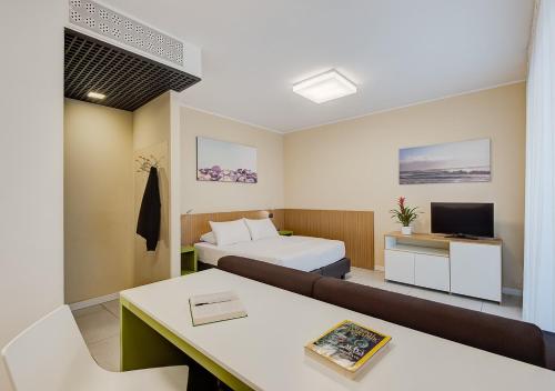 a hotel room with a bed and a couch at Camplus Turro Casa per Ferie in Milan