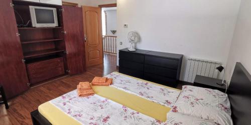 a living room with a couch and a tv at Villa Arcos in Segur de Calafell