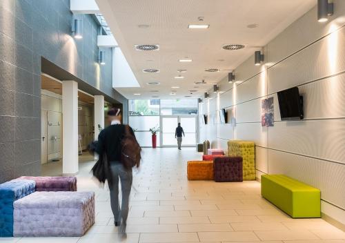 a person walking down a hallway in a building at Camplus Turro Casa per Ferie in Milan