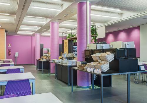a restaurant with purple walls and tables and purple pillars at Camplus Turro Casa per Ferie in Milan
