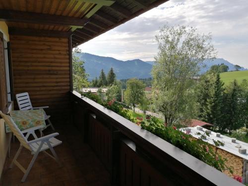 a balcony with a chair and a view of the mountains at Davidgut in Sankt Koloman