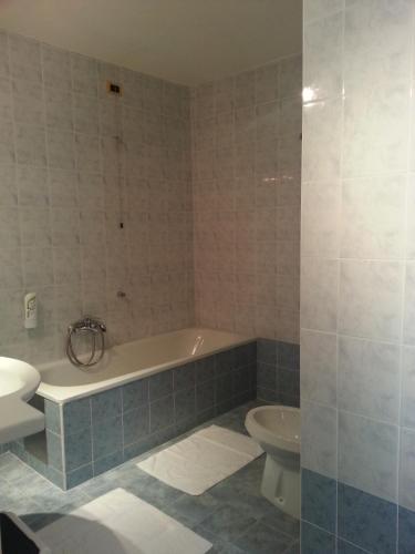 a bathroom with a bath tub and a toilet at Albergo Costantini in Tarcento