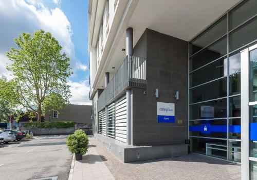 a building with a sign on the side of it at Camplus Turro Casa per Ferie in Milan