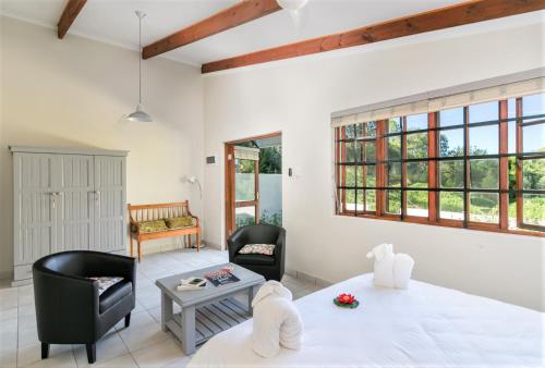 a living room with two chairs and a table at Eastbrook River Self Catering Cottages in Sedgefield