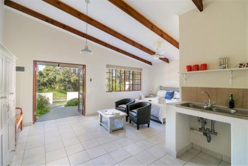 a kitchen and living room with a couch and a table at Eastbrook River Self Catering Cottages in Sedgefield