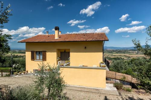 a small yellow house with a roof at Casa Montalgallo in Lucignano