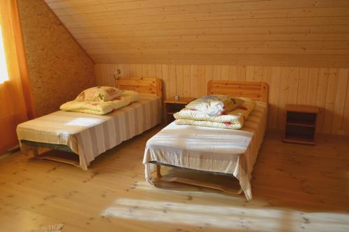 a room with two beds in a cabin at Rosma Mill Holiday House in Põlva