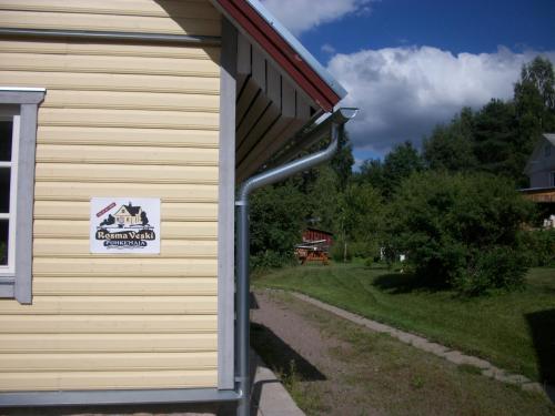 a building with a sign on the side of it at Rosma Mill Holiday House in Põlva