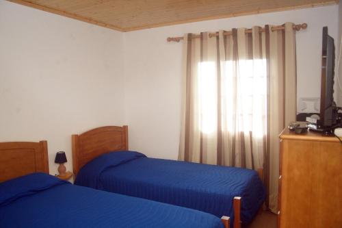 Ένα ή περισσότερα κρεβάτια σε δωμάτιο στο Retiro dos Cabritos