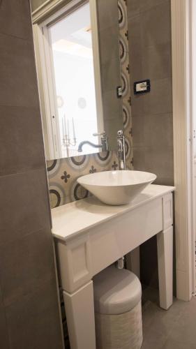 a bathroom with a white sink and a mirror at BellaVita accomodation in Tropea