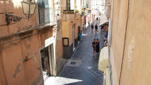 a group of people walking down a narrow street at BellaVita accomodation in Tropea