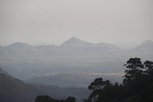 a misty valley with mountains in the distance at Welcome Inn in Ella