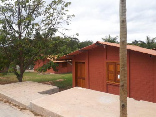 a small red building with a pole in front of it at Pousada Kart Clube in São João del Rei