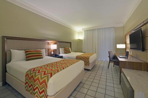 Ein Bett oder Betten in einem Zimmer der Unterkunft Hotel Deville Prime Salvador